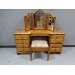 A contemporary pine dressing table fitted eight drawers with mirror back and stool