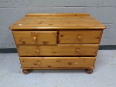 A contemporary pine four drawer low chest