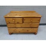 A contemporary pine four drawer low chest