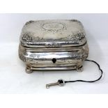 A 19th century German silver tea caddy, coat of arms to lid, on ball feet, original silver key.