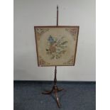 A Victorian tapestry pole screen