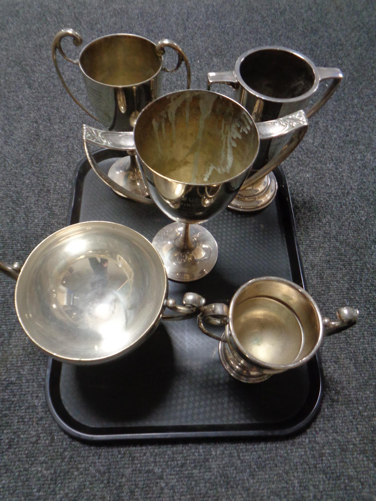 A tray containing five silver plated presentation trophies
