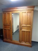 A mahogany triple door compactum wardrobe