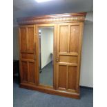 A mahogany triple door compactum wardrobe