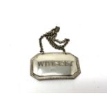 A silver plated decanter label - whisky
