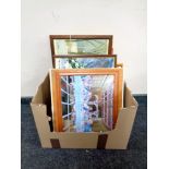 A box containing assorted pictures and prints,