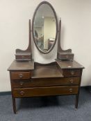 A late Victorian inlaid mahogany sunk centre dressing table with mirror back