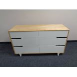 A contemporary pine effect six drawer chest