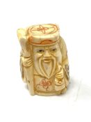 A carved Chinese bone netsuke - Bearded Gentleman with staff and gown