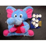 A tray containing Ringtons and other commemorative mugs together with an elephant soft toy and a