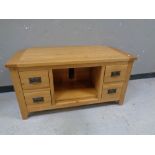 A contemporary oak entertainment stand fitted four drawers