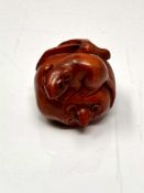 A carved Chinese hardwood netsuke - Two rats on fruit