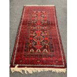 An Afghan rug of geometric design,