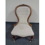 A Victorian carved walnut lady's chair in button upholstery
