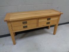 A contemporary oak four drawer side table