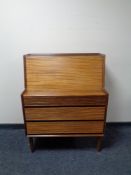 A mid 20th century teak fall front bureau fitted three drawers beneath