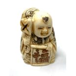 A carved Chinese bone netsuke - Village elder carrying a large bag