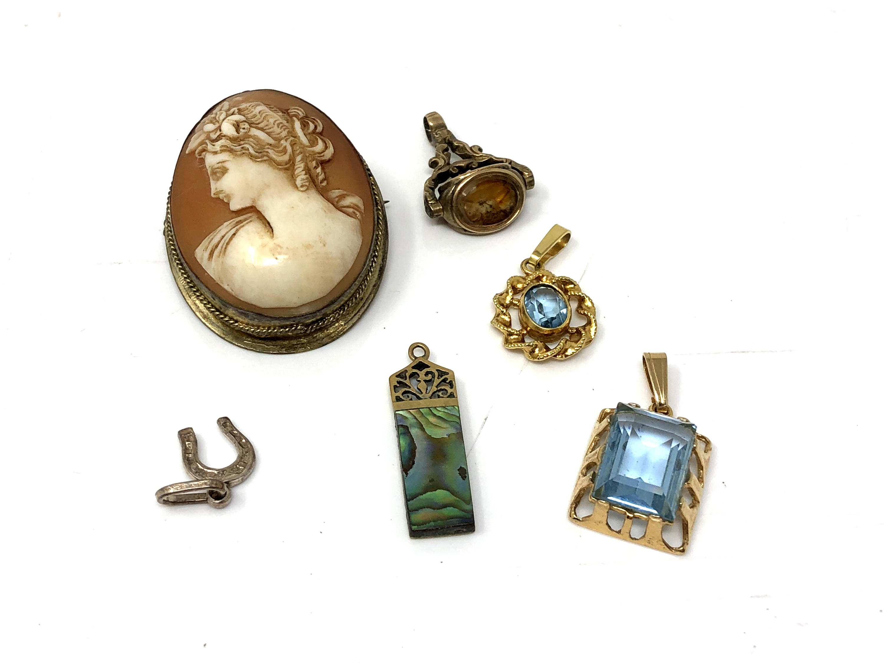 An antique cameo brooch together with pendants,