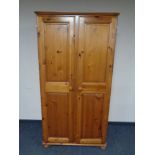 A contemporary pine double door wardrobe