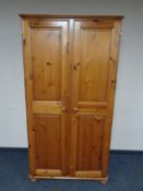 A contemporary pine double door wardrobe