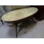 An onyx topped oval occasional table on ornate brass base