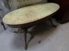 An onyx topped oval occasional table on ornate brass base