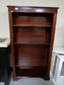 A reproduction inlaid mahogany open bookcase