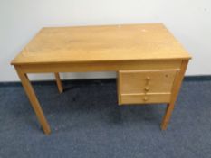 A mid 20th century oak desk fitted three drawers