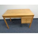 A mid 20th century oak desk fitted three drawers