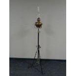 A wrought iron and brass standard oil lamp