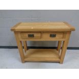 A contemporary oak two drawer side table