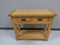 A contemporary oak two drawer side table