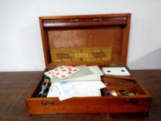 An Edwardian mahogany games box containing drafts, counters, cards,