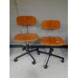 A pair of swivel desk chairs