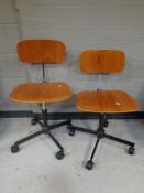 A pair of swivel desk chairs