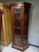 A contemporary hardwood glazed display cabinet