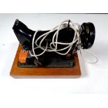 A vintage Singer electric sewing machine with pedal