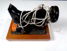 A vintage Singer electric sewing machine with pedal