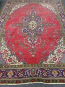 A Persian Kirman carpet on red and green ground,