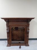 A continental carved oak glazed bookcase top