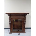 A continental carved oak glazed bookcase top