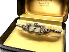 A lady's wrist watch in platinum case,