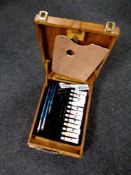 A wooden artist's box containing paints,