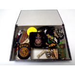 A box containing a large quantity of assorted militaria including badges and insignia, buttons,