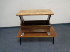 An oak magazine rack together with a mid 20th century low coffee table on metal legs