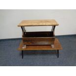 An oak magazine rack together with a mid 20th century low coffee table on metal legs