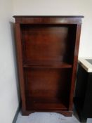 A reproduction inlaid mahogany open bookcase