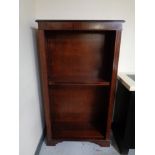 A reproduction inlaid mahogany open bookcase