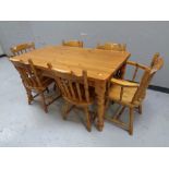 A contemporary pine farmhouse dining table fitted a drawer together with a set of six pine kitchen