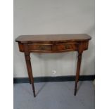 A reproduction mahogany serpentine front two drawer side table